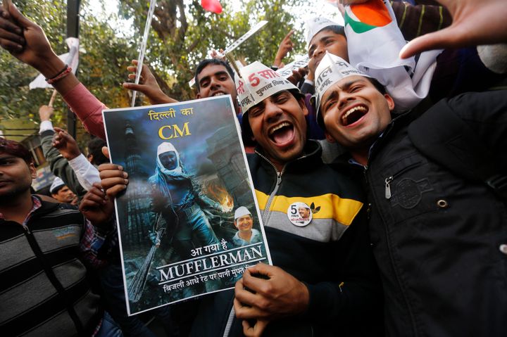 Supporters of Aam Aadmi (Common Man) Party (AAP) take part in the celebrations outside the AAP office in New Delhi February 10, 2015. The upstart anti-establishment party crushed India's ruling Bharatiya Janata Party in an election for the Delhi assembly on Tuesday, smashing an aura of invincibility built around Prime Minister Narendra Modi since he swept to power last year. REUTERS/Adnan Abidi (INDIA - Tags: POLITICS ELECTIONS)