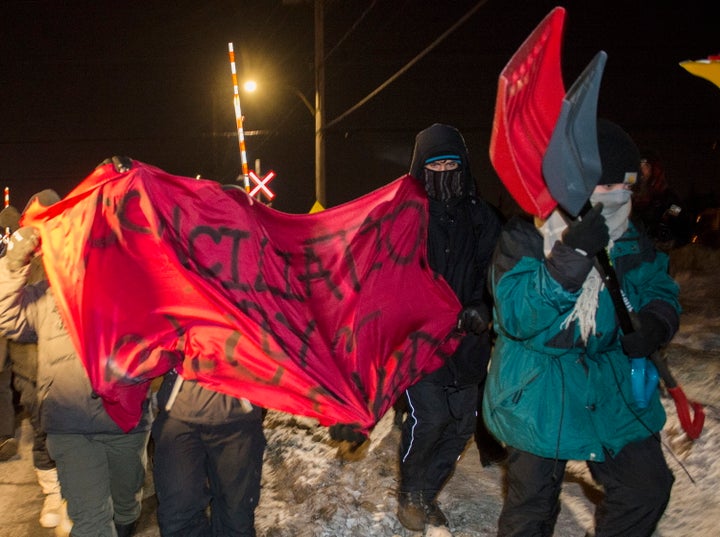 Protesters leave a rail blockade in Saint-Lambert, Que. on Friday.