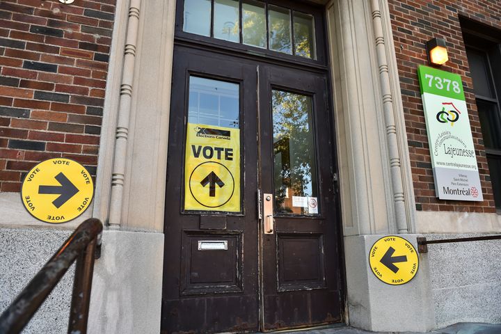 Signs direct Canadian voters on election day at a polling station in Montreal on Oct. 21, 2019.