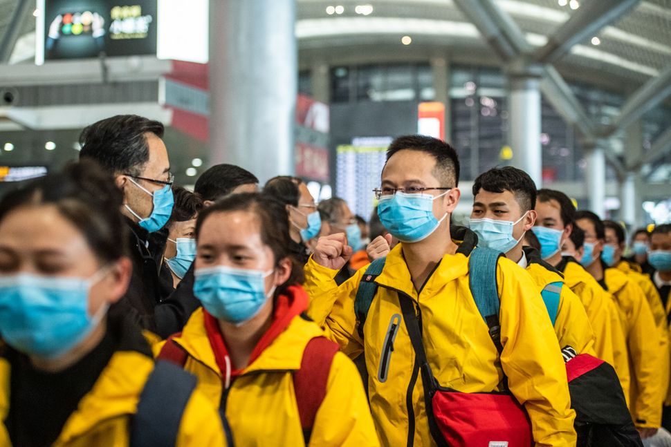 Members of a medical team attend a ceremony before leaving for Hubei Province at the Guiyang Longdongbao International Airport.