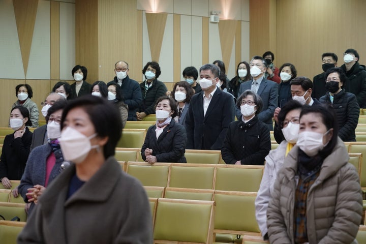 Christian faithful wearing masks to prevent contacting coronavirus pray during a service in Seoul, South Korea, February 23, 2020.