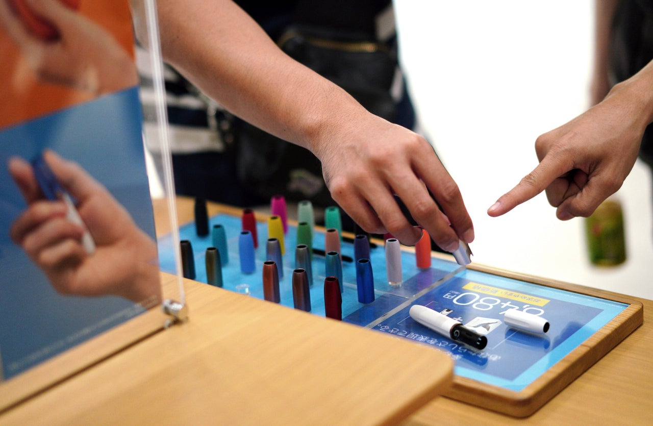 Visitors look at an Iqos range in Tokyo. 