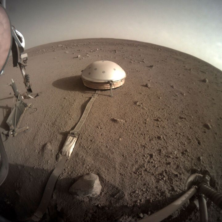 This Feb. 18, 2020 photo made available by NASA shows the InSight lander's dome-covered seismometer, known as SEIS, on Mars. On Monday, Feb. 24, 2020, scientists reported that the spacecraft has detected hundreds of quakes and even aftershocks that are regularly jolting the red planet. (NASA/JPL-Caltech via AP)