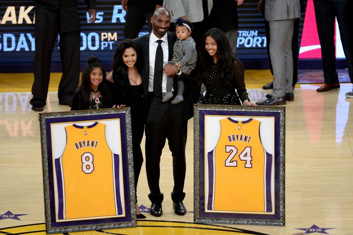 Kobe Bryant poses with his family after both his Los Angeles Lakers jerseys, numbers 8 and 24, are retired at the Staples Center on Dec. 18, 2017.
