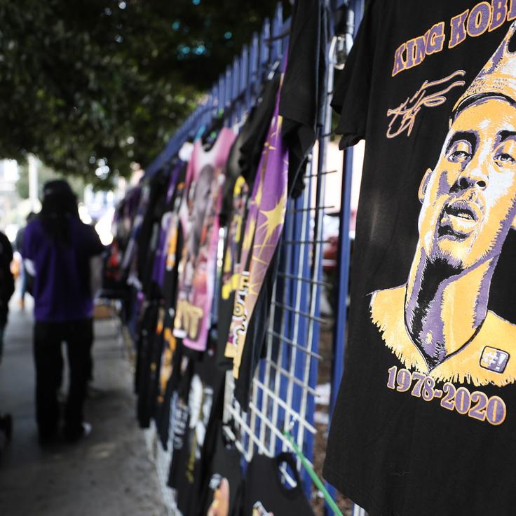 Memorabilia is sold outside the "Celebration of Life for Kobe and Gianna Bryant" on Monday at Staples Center in Los Angeles. Retired NBA star Kobe Bryant, 41, and his 13-year-old daughter, Gianna, were killed along with seven others in a helicopter crash near Los Angeles on Jan. 26.