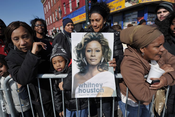People gather outside New Hope Baptist Church during a private funeral for singer Whitney Houston on Feb. 18, 2012, in Newark, New Jersey.