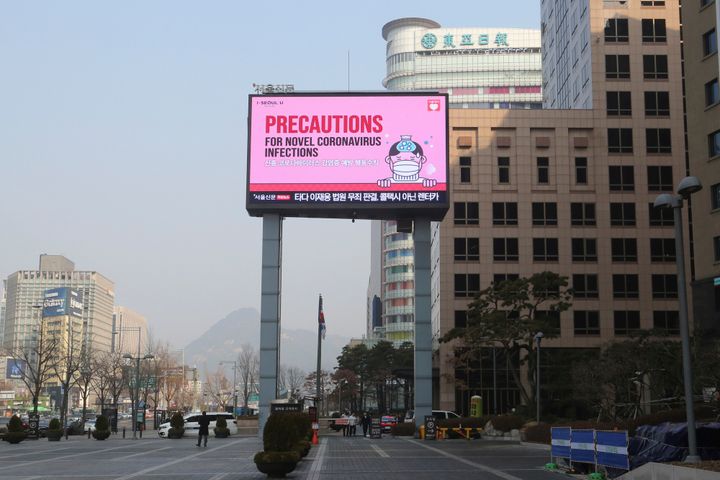 A huge electric screen broadcasts precautions against the COVID-19 outbreak in Seoul on Feb. 20.