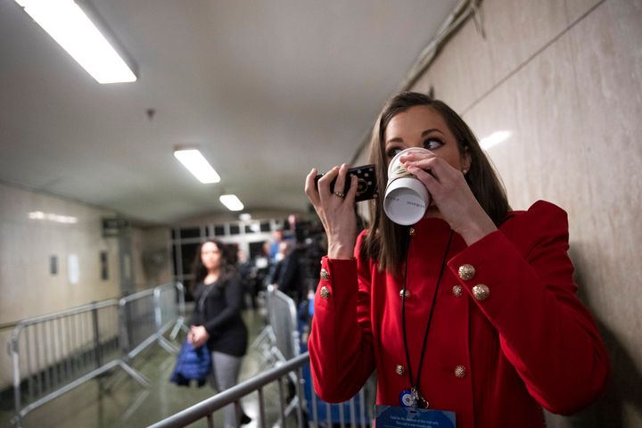 Court TV legal correspondent Chanley Painter drinks coffee and talks on the phone while waiting for Harvey Weinstein to arrive at a Manhattan courthouse for his rape trial, Tuesday, Feb. 18, 2020, in New York.