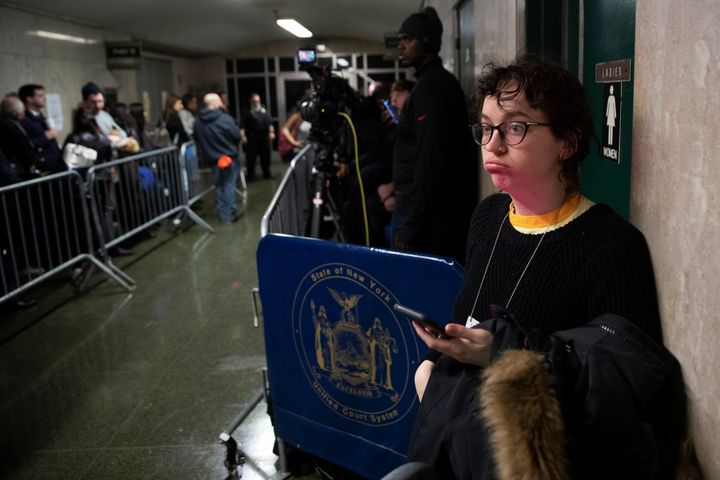 Freelance reporter working for Vulture magazine Victoria Bekiempis waits in the hallway during Harvey Weinstein's rape trial, Tuesday, Feb. 18, 2020, in New York. 