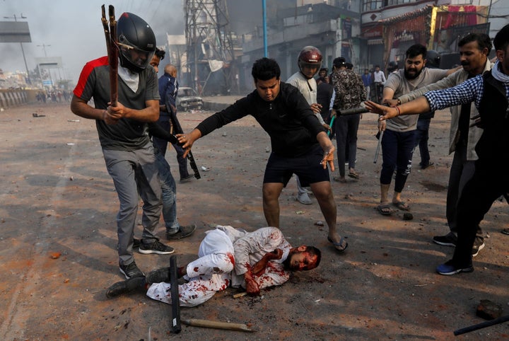 SENSITIVE MATERIAL. THIS IMAGE MAY OFFEND OR DISTURB People supporting the new citizenship law beat a Muslim man during a clash with those opposing the law, in New Delhi, India, February 24, 2020. REUTERS/Danish Siddiqui