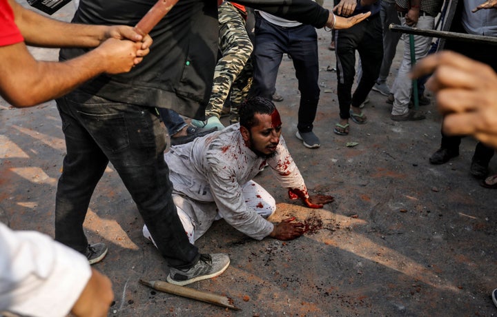 SENSITIVE MATERIAL. THIS IMAGE MAY OFFEND OR DISTURB People supporting the new citizenship law beat a Muslim man during a clash with those opposing the law, in New Delhi, India, February 24, 2020. REUTERS/Danish Siddiqui