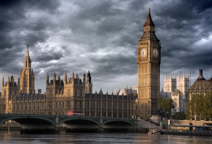 UK London Big Ben and Westminster bridge viewed over the river Thames stormy Skies