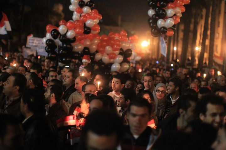 Thousands of Egyptian Muslims and Coptic Christians attend a celebration on New Year's eve in Tahrir Square in Cairo, on December 31, 2011.