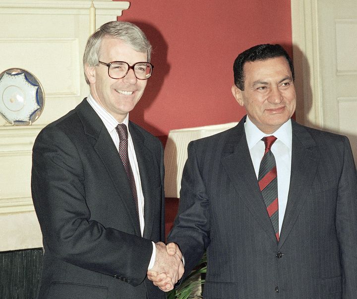 John Major, left, shakes hands with Egyptian President Hosni Mubarak, right, prior to their meeting at 10 Downing Street, on Wednesday, July 24, 1991.