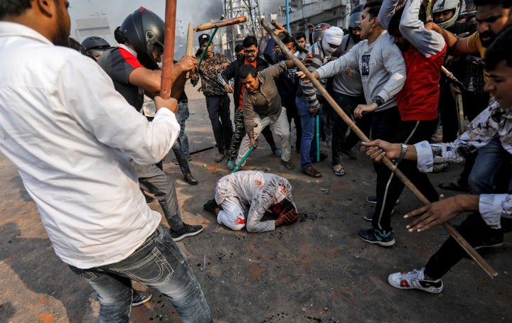 Trigger warning: CAA supporters beat a Muslim man during riots in Delhi on Monday. REUTERS/Danish Siddiqui