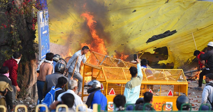 Protesters during violent clashes between anti- and pro-CAA demonstrations, at Jaffarabad, near Maujpur on Feb. 24, 2020, in New Delhi, India. 