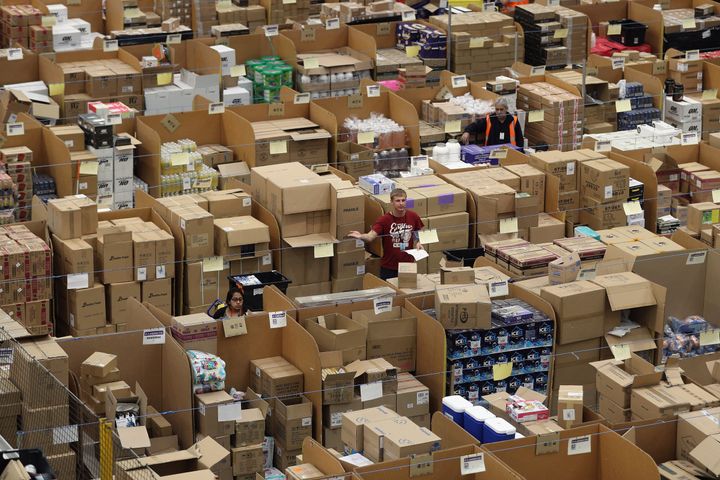 Parcels are processed and prepared for dispatch at Amazon's fulfillment center in Peterborough, England.
