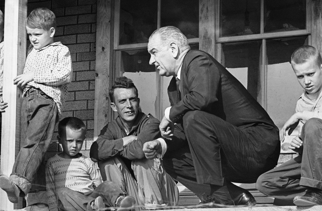 President Lyndon Johnson listens to Tom Fletcher, father of eight, describe some of the problems facing the residents of Inez, Kentucky, in April 1964.