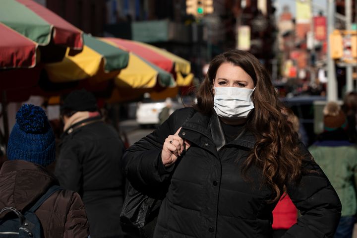 A woman, who declined to give her name, wears a mask out of concern for the coronavirus in New York. Health officials on Tues