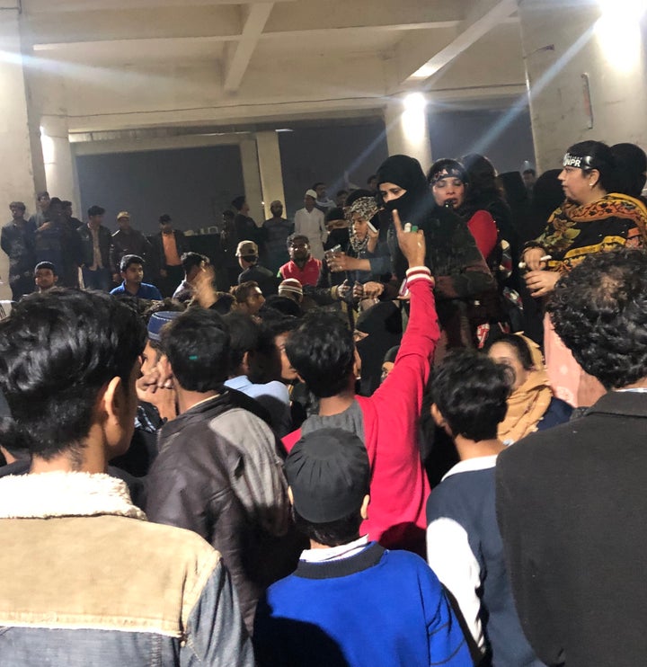 Male supporters surrounding some of the women activists who were in disagreement about withdrawing the sit-in protest from the Jafrabad metro station venue.