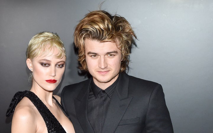 Maika Monroe and Joe Keery attend the Saint Laurent show at Paris Fashion Week.