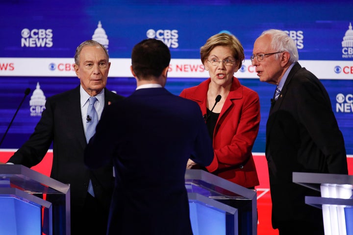 Former New York Mayor Mike Bloomberg, former South Bend, Indiana, Mayor Pete Buttigieg, Sen. Elizabeth Warren (D-Mass.) and Sen. Bernie Sanders (I-Vt.) talk to one another after the Democratic presidential primary debate Tuesday at the Gaillard Center in Charleston, South Carolina.