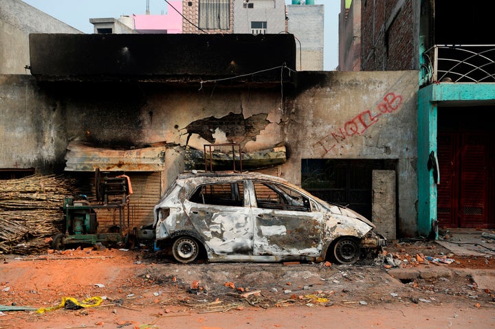 A burnt-out vehicle is pictured following riots in New Delhi, on February 26, 2020. 