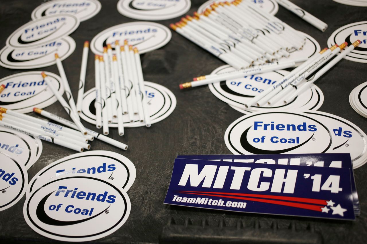 Bumper stickers for Sen. Mitch McConnell sit on a table alongside "Friends of Coal" advocacy stickers during a campaign stop in Lexington, Kentucky, on Oct. 31, 2014. 