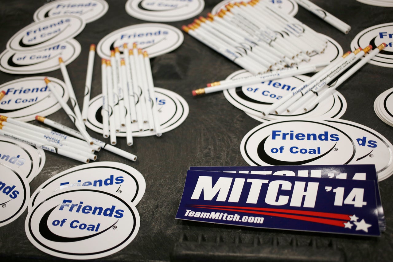Bumper stickers for Sen. Mitch McConnell sit on a table alongside "Friends of Coal" advocacy stickers during a campaign stop in Lexington, Kentucky, on Oct. 31, 2014.