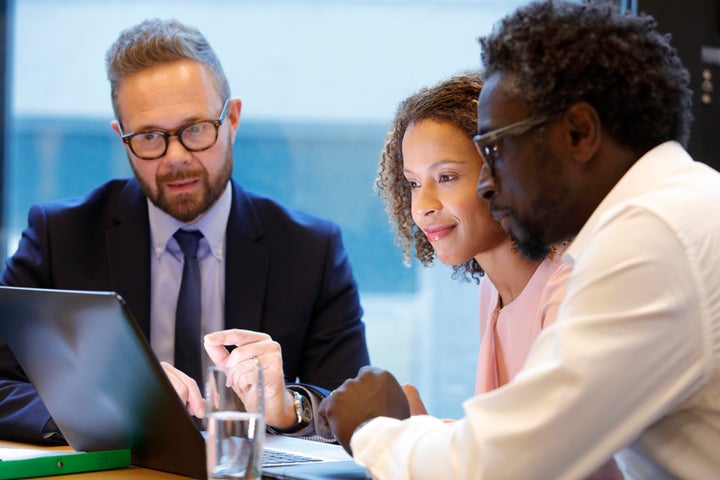 A financial adviser meets with clients in this stock image. It's best to reveal any outstanding debt when getting a mortgage pre-approval as a credit check will uncover them.