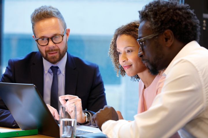 A financial adviser meets with clients in this stock image. It's best to reveal any outstanding debt when getting a mortgage pre-approval as a credit check will uncover them.