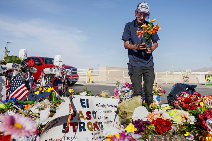 Antonio Basco, whose wife, Margie Reckard, was one of 22 killed by a gunman at a local Walmart, lays flowers in her honor at a makeshift memorial near the scene on August 16, 2019, in El Paso, Texas.