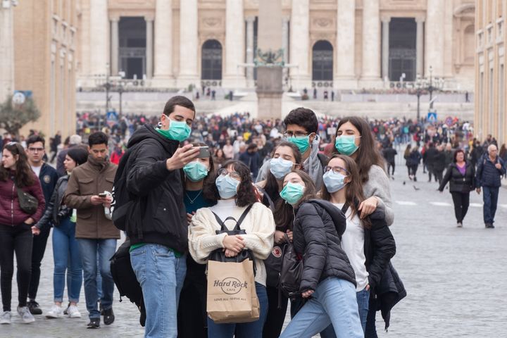 People wear face masks to protect themselves while visiting the Vatican on Ash Wednesday.