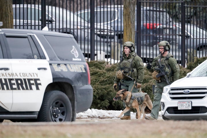 Police conduct searches outside the Molson Coors campus in Milwaukee on Wednesday after reports of a possible shooting.