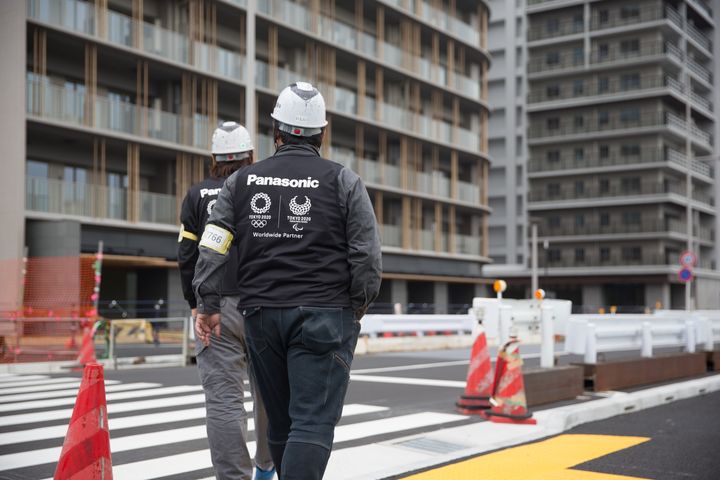 Construction site workers seen inspecting the Tokyo 2020 Olympic/Paralympic Village in Tokyo