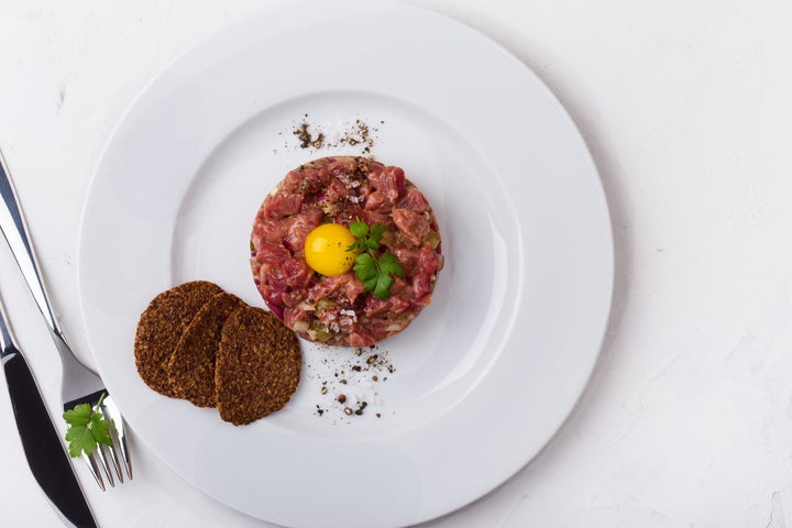 Steak tartare, a popular dish made with raw beef and uncooked egg yolks.