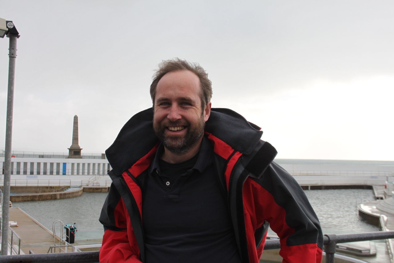 Jon Matthews of the Penzance & District Tourism Association, with the town's seawater swimming pool behind him.