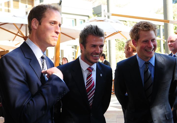 Prince William (left) and Prince Harry flank David Beckham at a reception in Johannesburg on June 19, 2010, in honor of the 2010 Football FIFA World Cup.