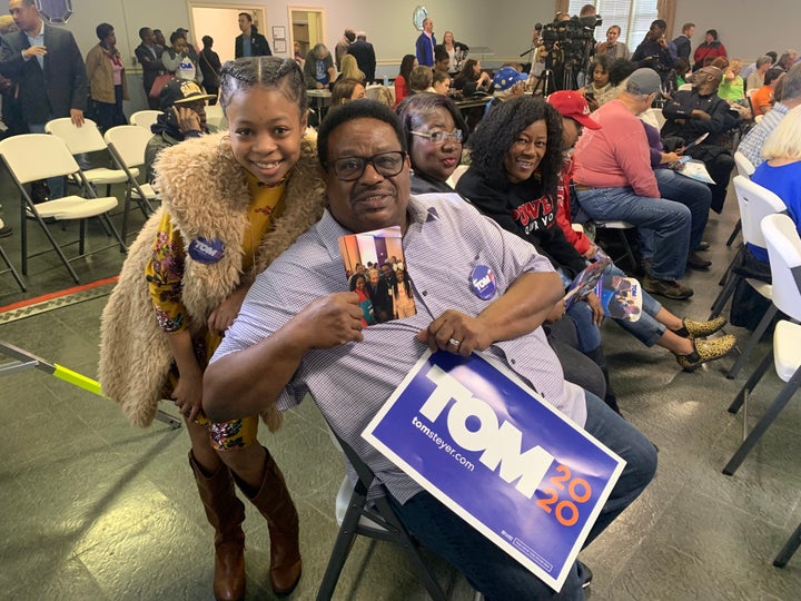 Tom Steyer supporter Wesley Gibson holds up a photo of him and the businessman taken at an impeachment rally in Washington, D.C.