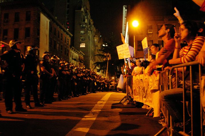 Police face protesters outside Madison Square Garden as then-President George W. Bush delivers his speech on the last day of the Republican National Convention in New York City.