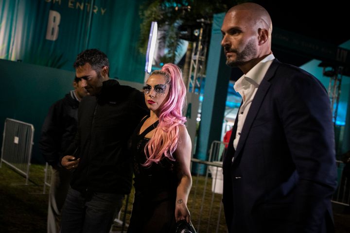 Lady Gaga and Michael Polanksy, left, leave the Super Bowl in Miami Gardens, Florida.