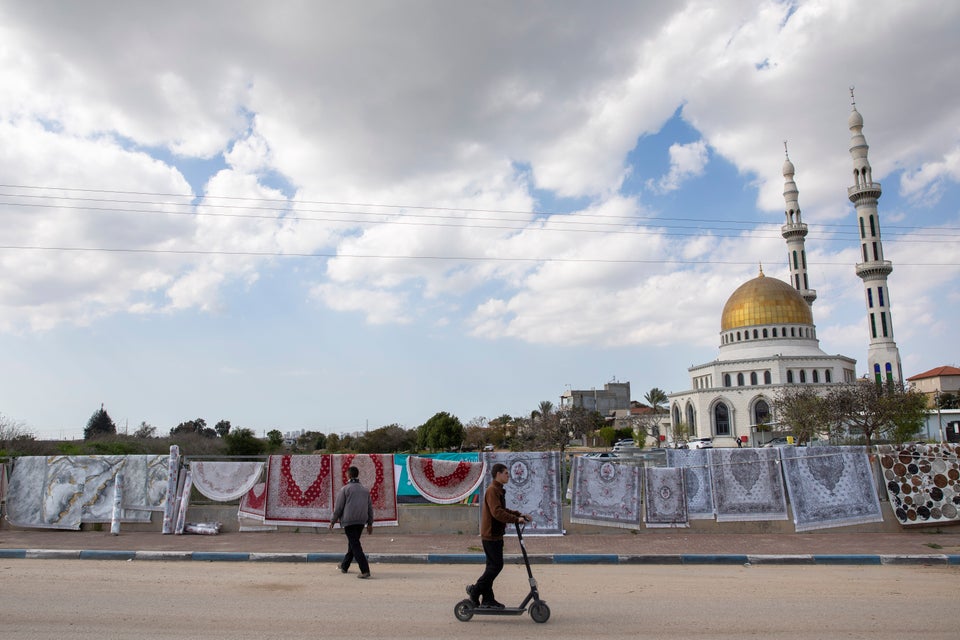 A man sells carpets at the Israeli Arab town of Jaljulia, Israel, Friday, Feb. 21, 2020. (AP Photo/Oded Balilty)