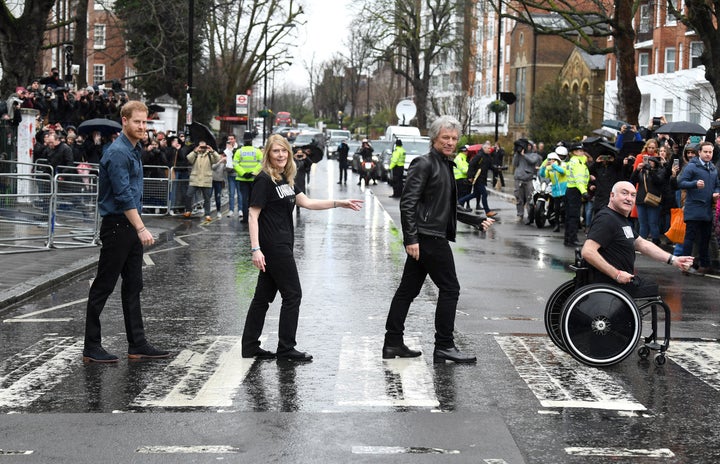 Prince Harry, Bon Jovi, and two members of the Invictus Games Choir recreate The Beatles' "Abbey Road" album cover.