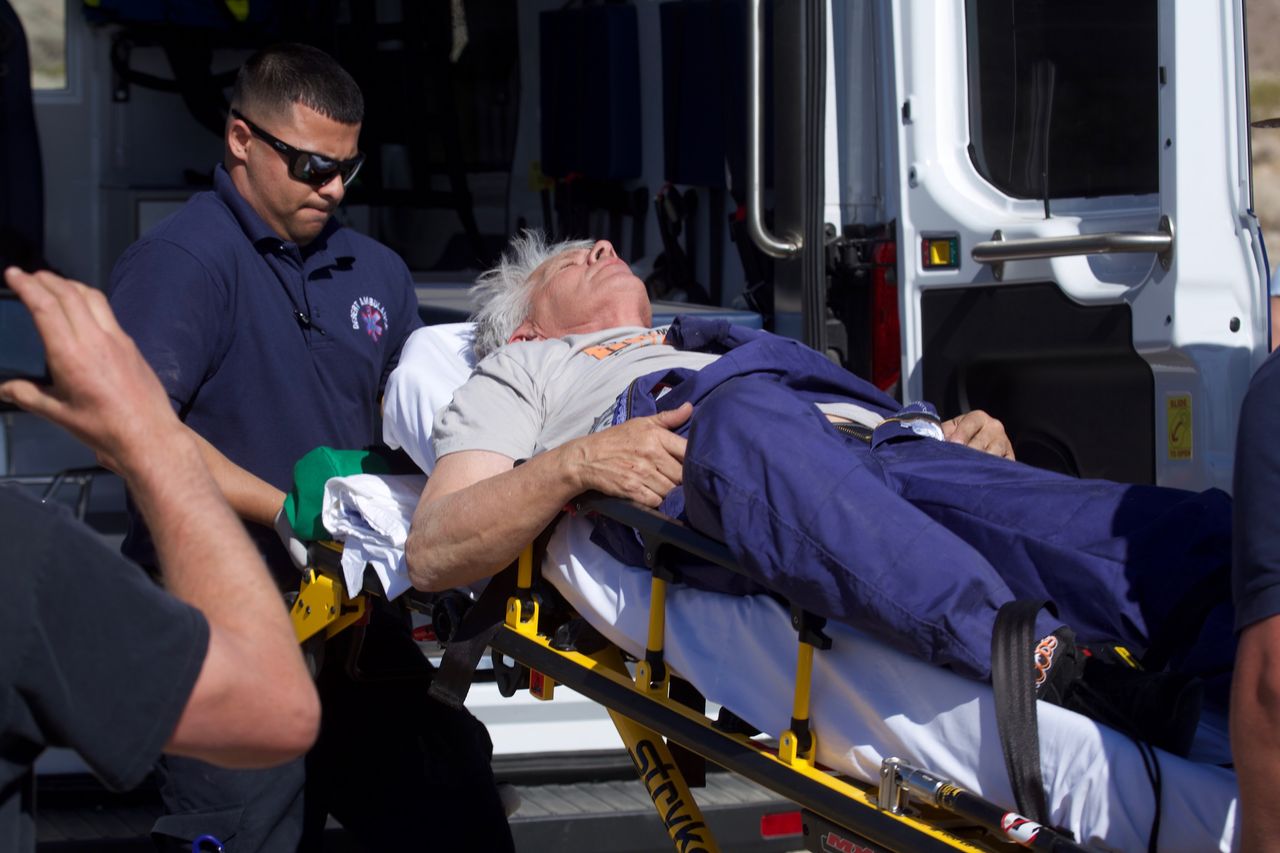 "Mad" Mike Hughes is carried on a stretcher after his home-made rocket launched and returned to the ground near Amboy, Calif., on Saturday, March 24, 2018. The self-taught rocket scientist who believes the Earth is flat propelled himself about 1,875 feet into the air before a hard-landing in the Mojave Desert that left him injured.