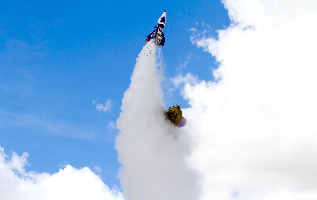A parachute gets caught in the thrust of Mad Mike's rocket during his final launch in Barstow, California, on February 22, 2020.