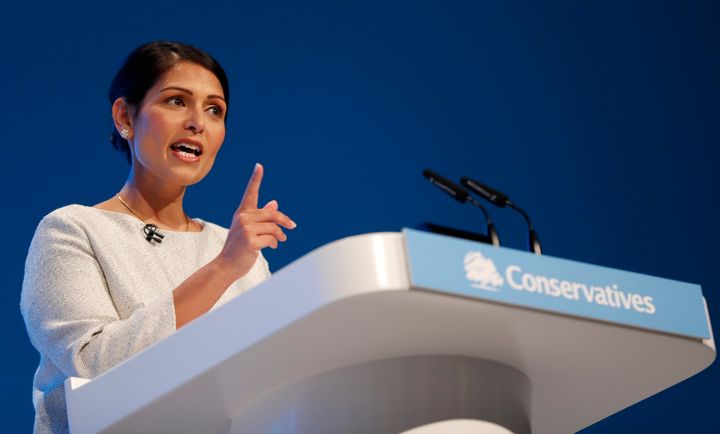 Britain's Home Secretary Priti Patel addresses the delegates at the Conservative Party Conference in Manchester, England, Tuesday, Oct. 1, 2019. Britain's ruling Conservative Party is holding their annual party conference.(AP Photo/Frank Augstein)