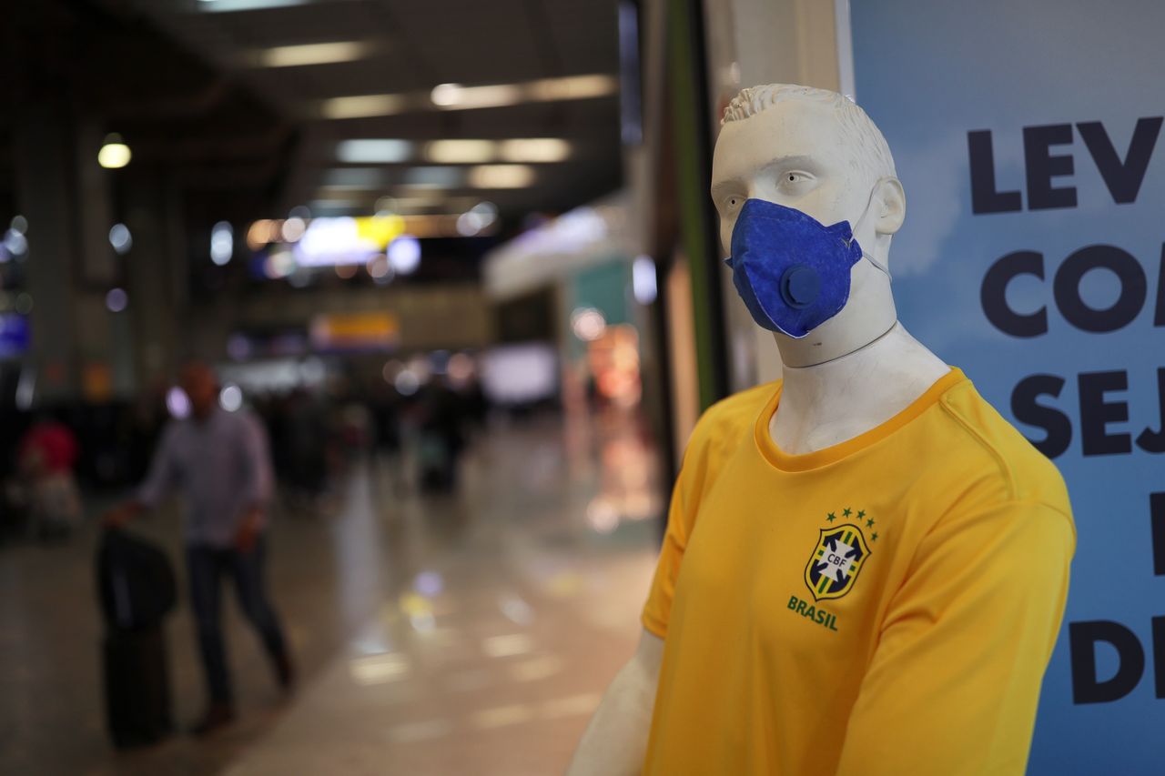 A mannequin wearing a protective mask and Brazil’s soccer jersey.