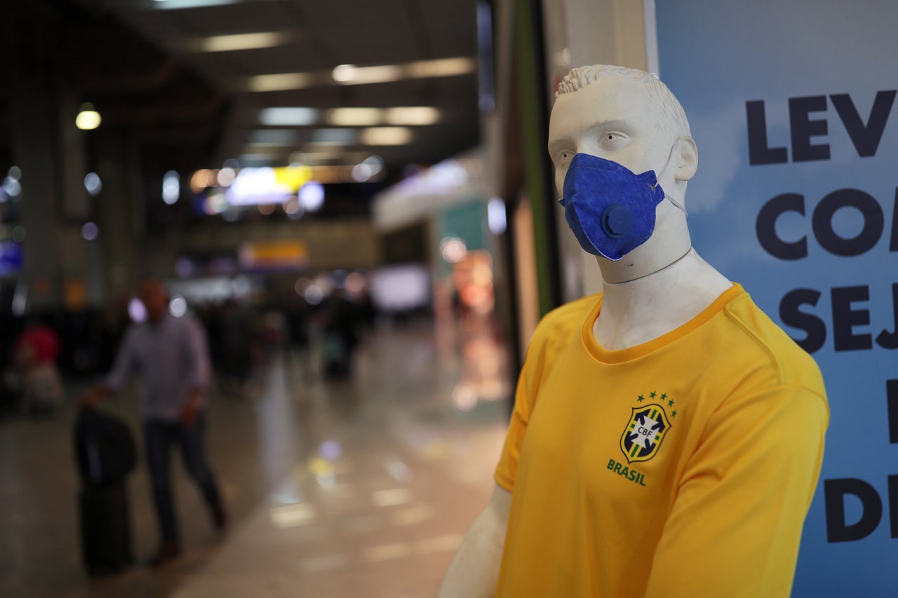 A mannequin wearing a protective mask and Brazil’s soccer jersey.