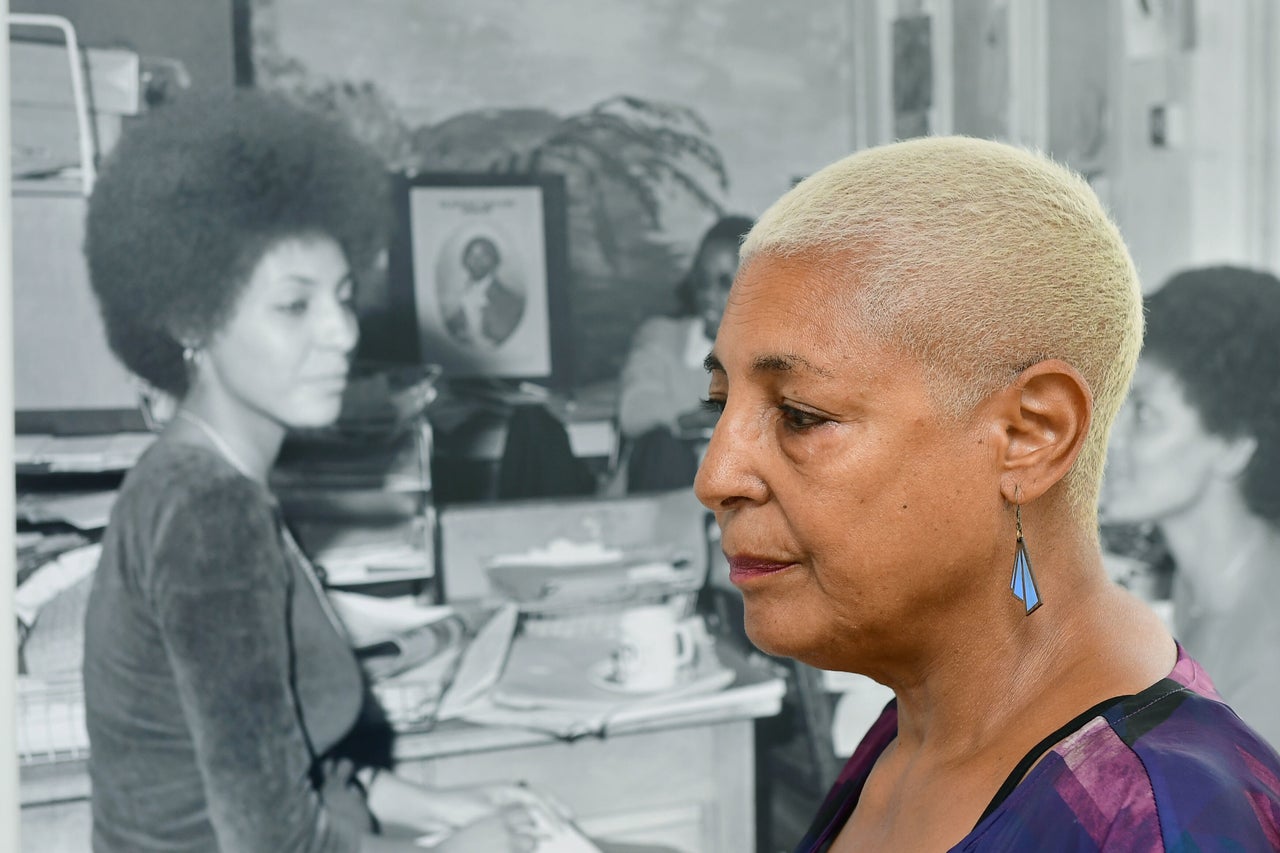 Leila Howe Hussan seen with a photo of her taken by Neil Kenlock at Expectations: The Untold Story of Black British Community Leaders in the 60s and 70s. 