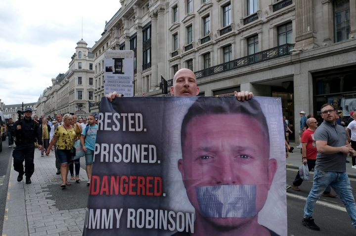 A supporter holds a banner during a rally outside the BBC in August 2019 to demand the freedom of Stephen Yaxley-Lennon